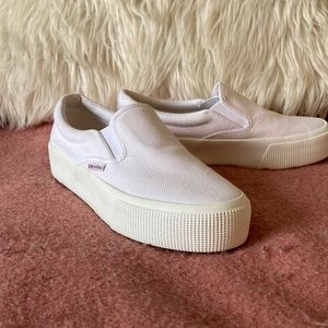 Superga white slide ons.